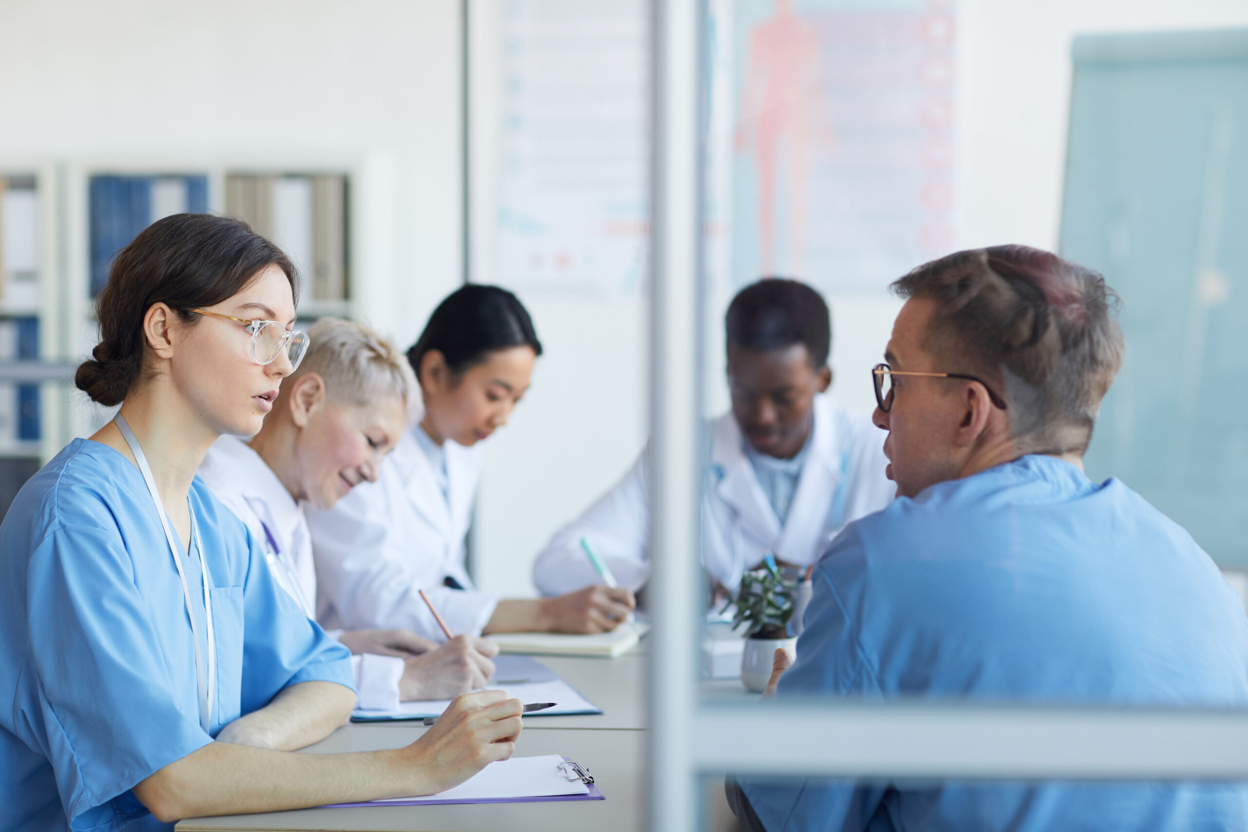 Portrait,Of,Young,Female,Doctor,Talking,To,Colleague,While,Sitting