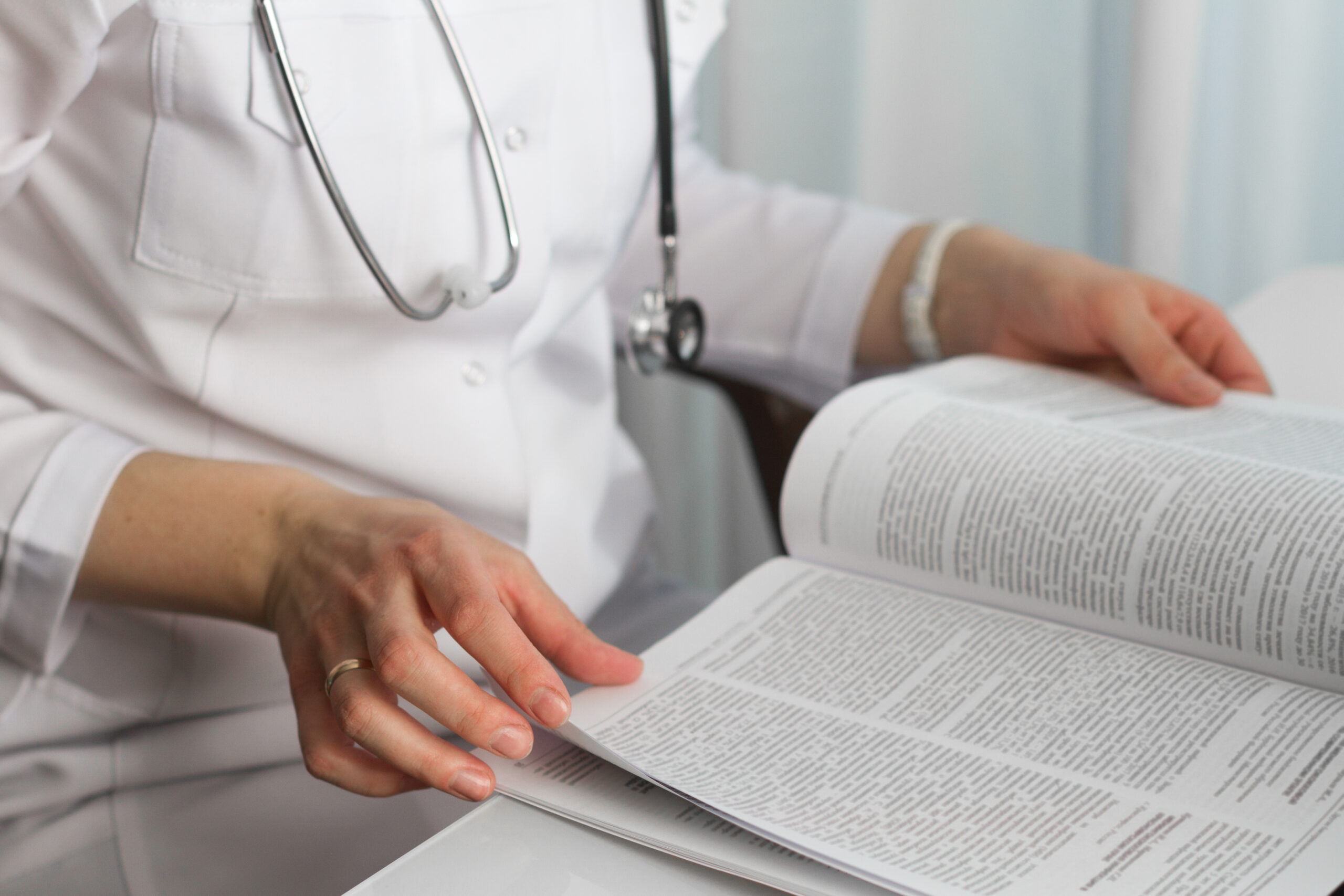 A doctor reading a publication