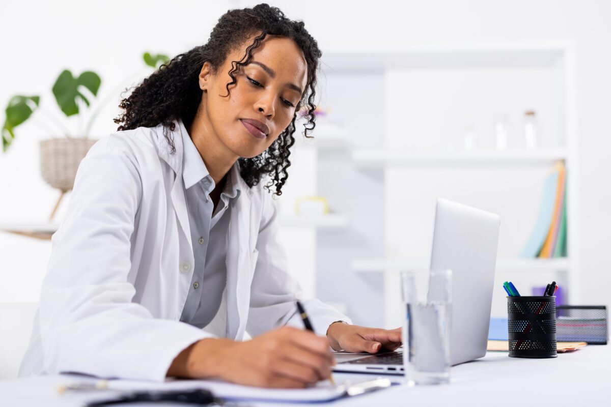 African,American,Mid,Adult,Female,Doctor,Writing,On,Clipboard,While African,American,Mid,Adult,Female,Doctor,Writing,On,Clipboard,While
