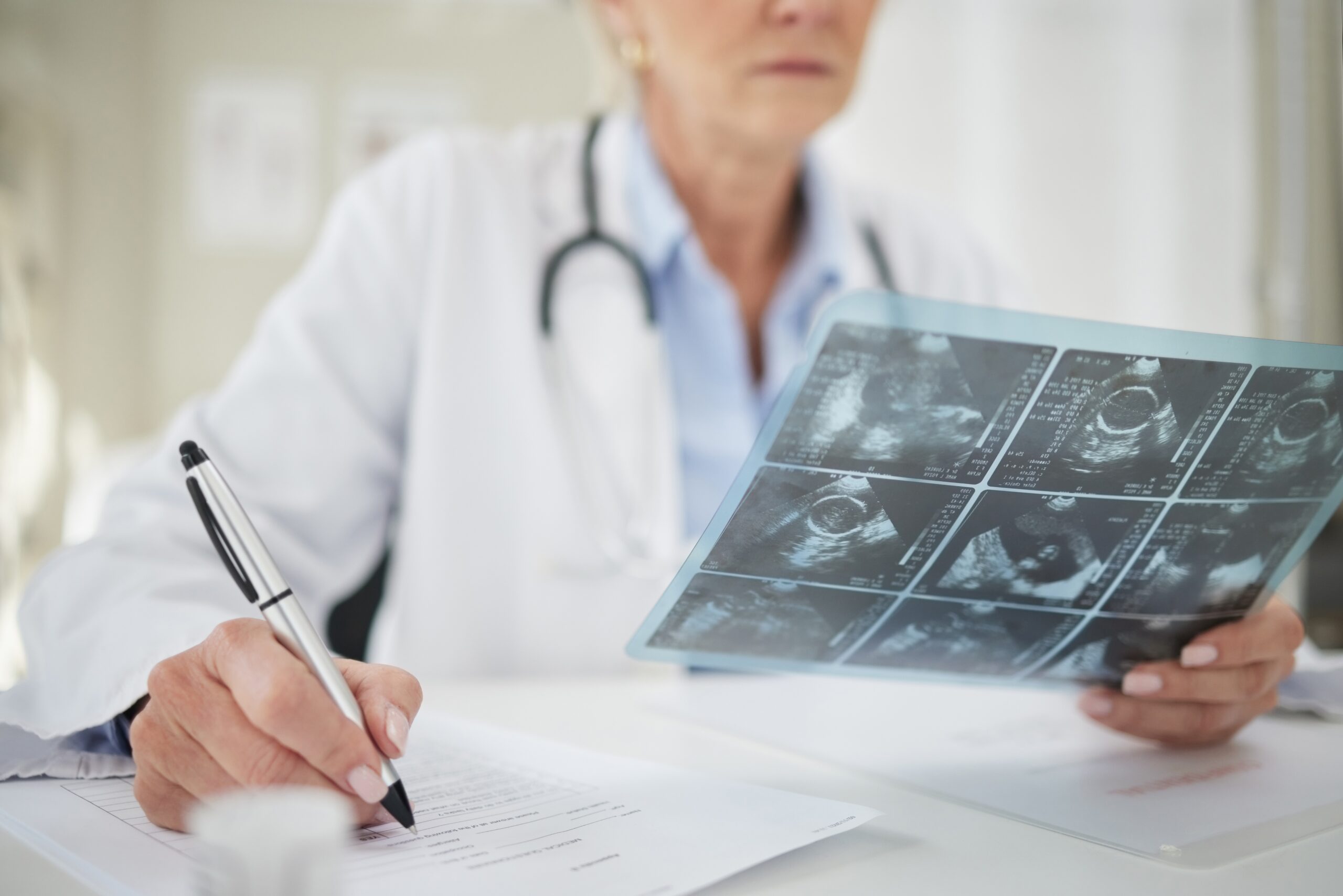 Doctor,,Writing,And,Ultrasound,Scan,In,Hospital,For,Healthcare,,Pregnancy