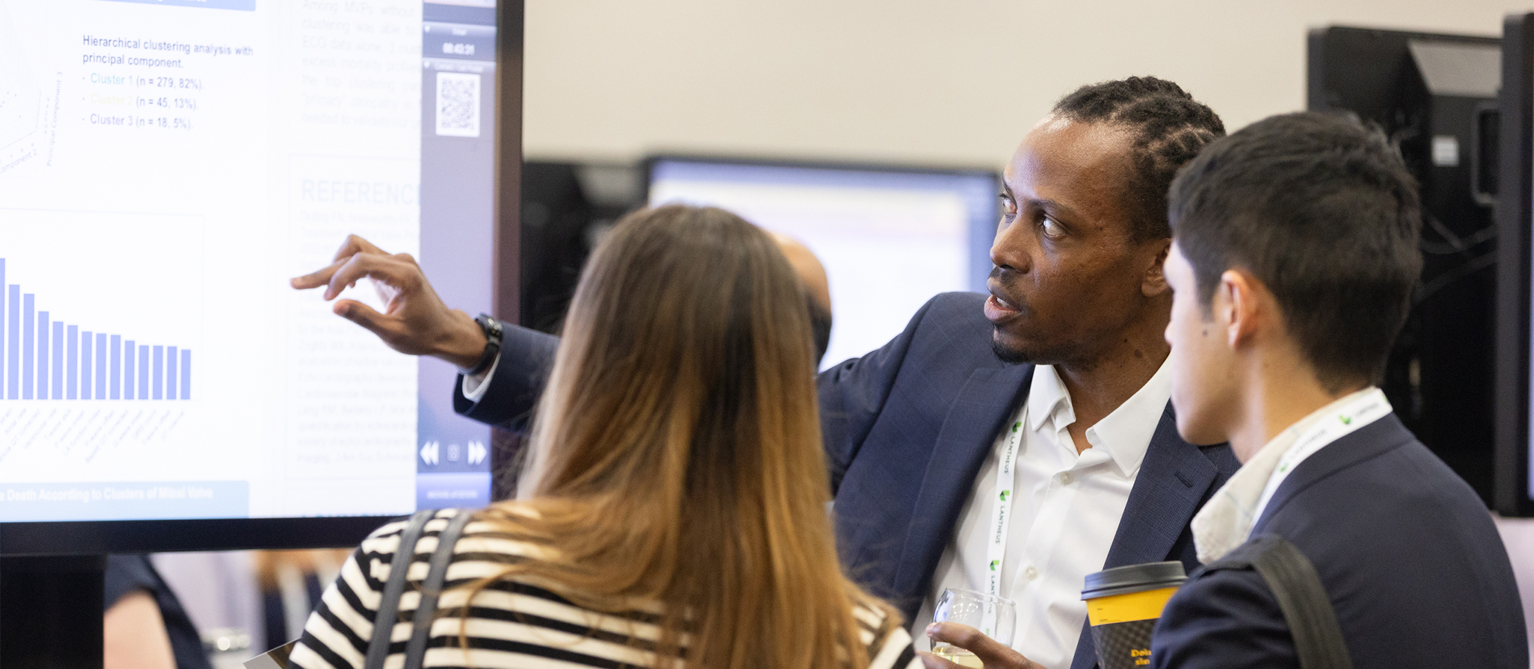 Man showing his report to female and male colleague